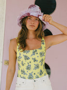 Acacia yellow Petal Mountain one-piece swimsuit showcased in Fashion Revolution Week campaign photoshoot, featuring a vibrant native floral print and sustainable fabric.